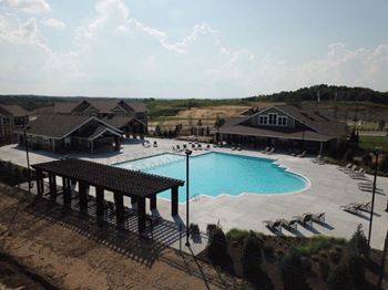 a large swimming pool in front of a house at The Venue at 109 Apartments , Lebanon, Tennessee